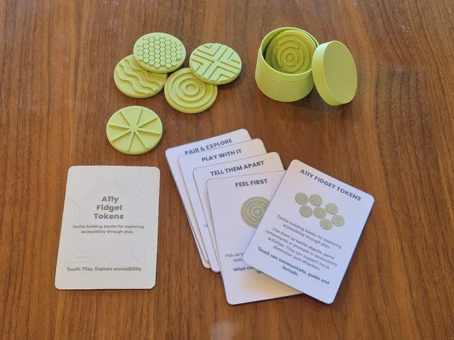 Six pale green tokens with different raised textures — honeycomb, waves, concentric rings, a maze, cross-hatching and spokes — beside a round storage tin and the A11y Fidget Tokens cards.